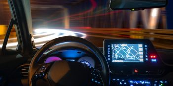 concept of the cockpit of an autonomous car driving at night illuminated by a tunnel